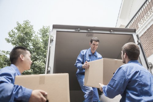 Boxes and furniture being loaded into a removal van