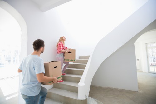 Professional movers handling furniture carefully in a Belsize Park property