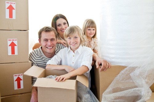Local movers handling furniture carefully near Belsize Park flats